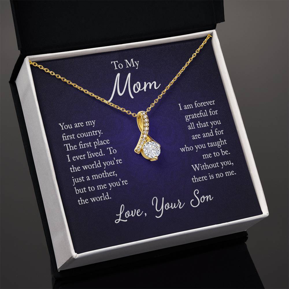 Alluring Beauty necklace features a petite ribbon shaped pendant with message card To Mom