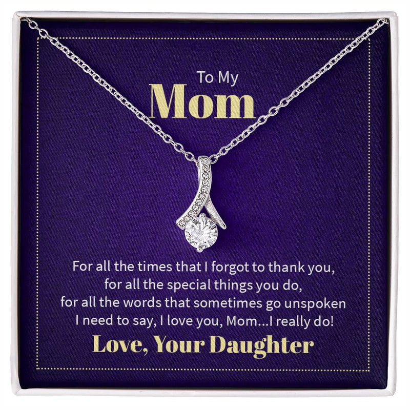 Alluring Beauty necklace features a petite ribbon shaped pendant with message card To Mom