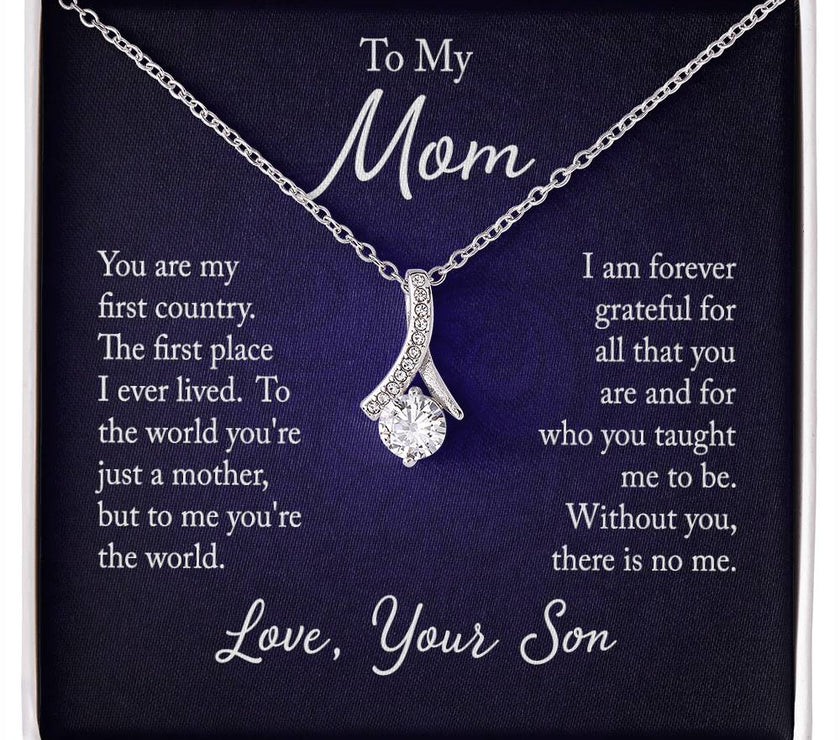 Alluring Beauty necklace features a petite ribbon shaped pendant with message card To Mom