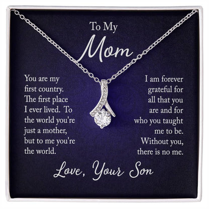 Alluring Beauty necklace features a petite ribbon shaped pendant with message card To Mom