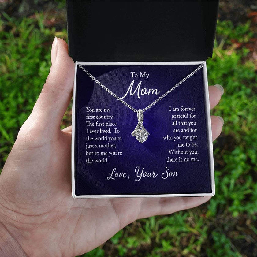 Alluring Beauty necklace features a petite ribbon shaped pendant with message card To Mom