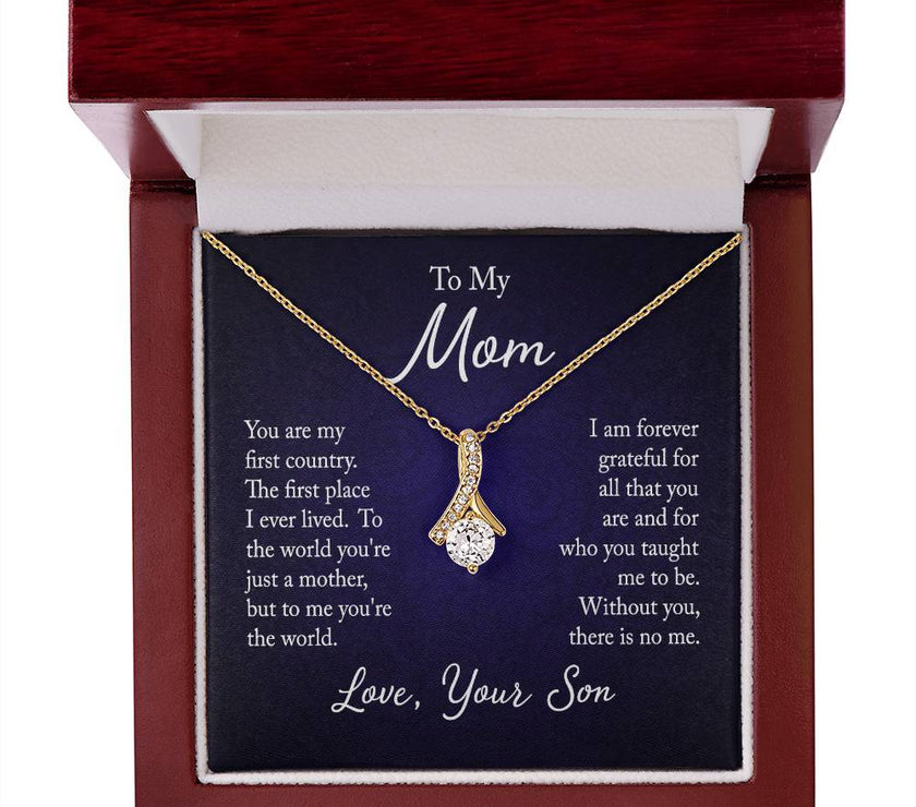 Alluring Beauty necklace features a petite ribbon shaped pendant with message card To Mom