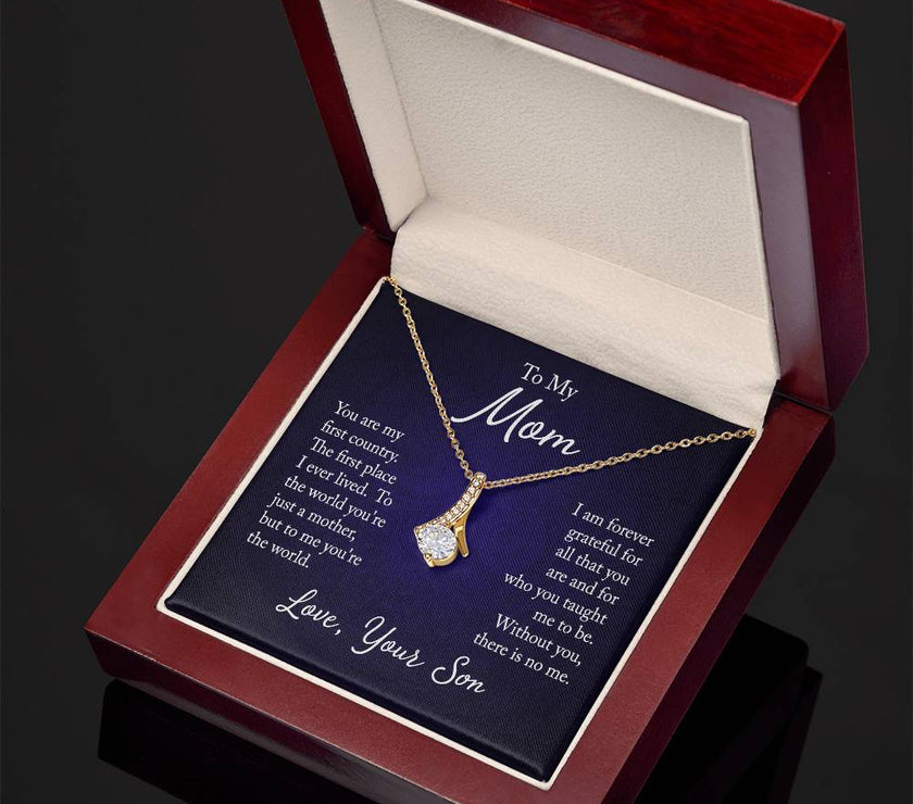 Alluring Beauty necklace features a petite ribbon shaped pendant with message card To Mom