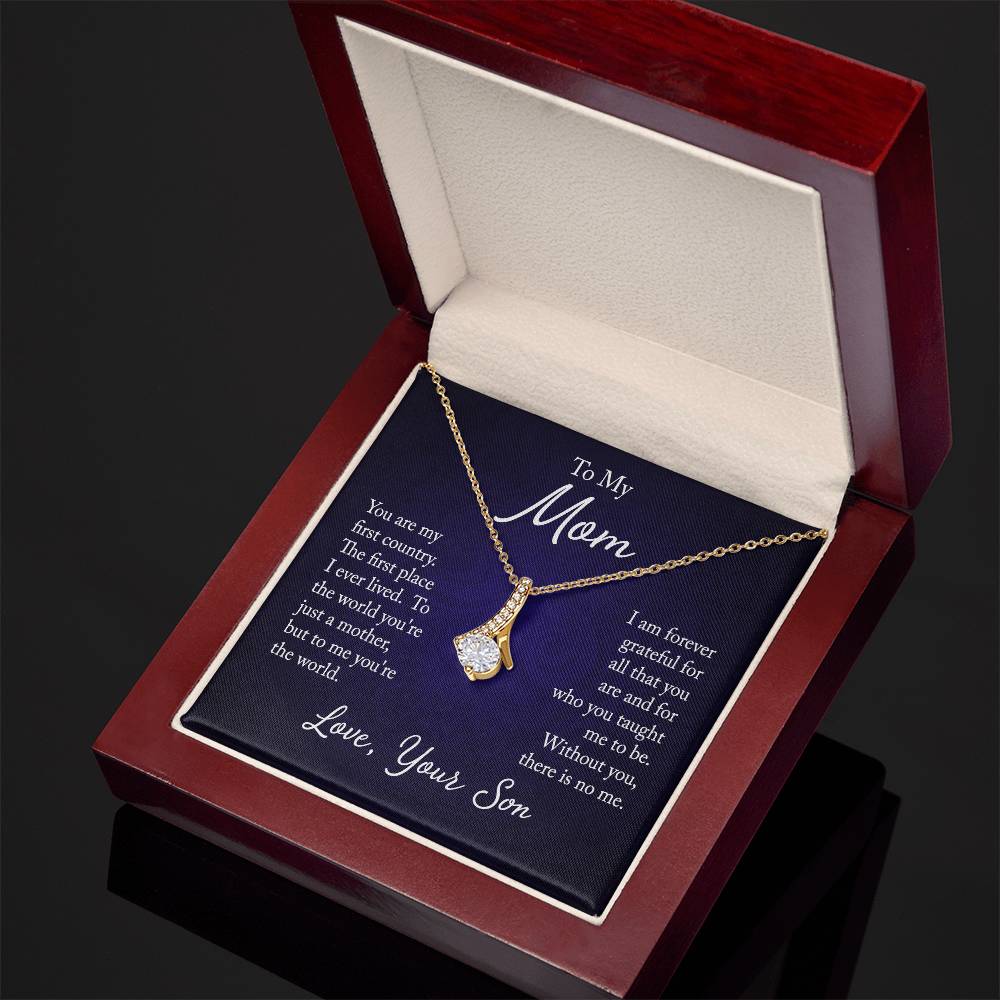 Alluring Beauty necklace features a petite ribbon shaped pendant with message card To Mom