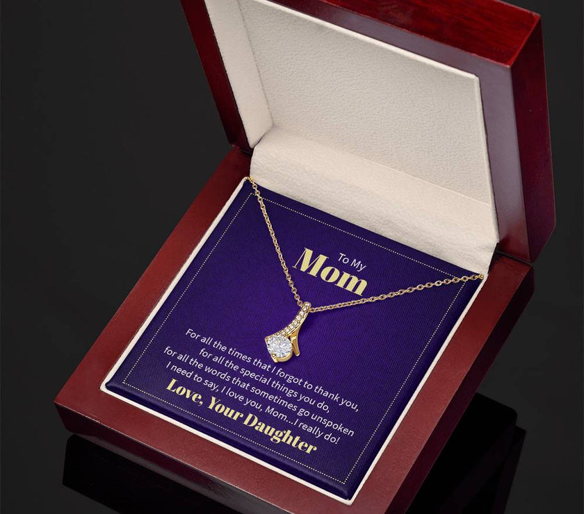 Alluring Beauty necklace features a petite ribbon shaped pendant with message card To Mom  18k yellow gold finish