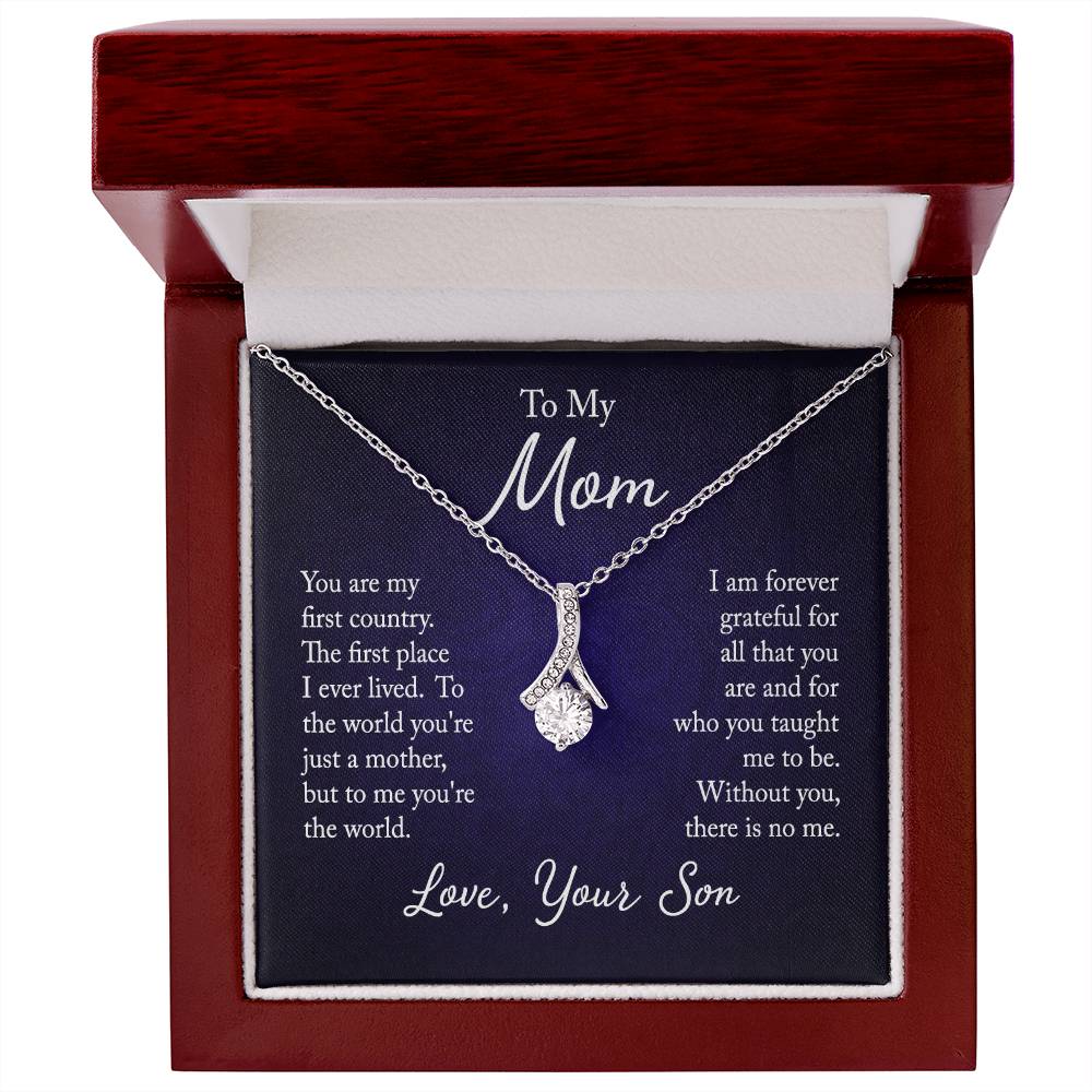 Alluring Beauty necklace features a petite ribbon shaped pendant with message card To Mom