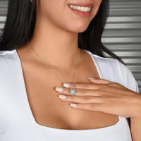 Silver love knot necklace with a sparkling center stone  symbolizing eternal love and romantic connection.