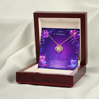 Gold love knot necklace with a sparkling center stone displayed on a purple Valentine’s Day background with glowing hearts, symbolizing eternal love and romantic connection.