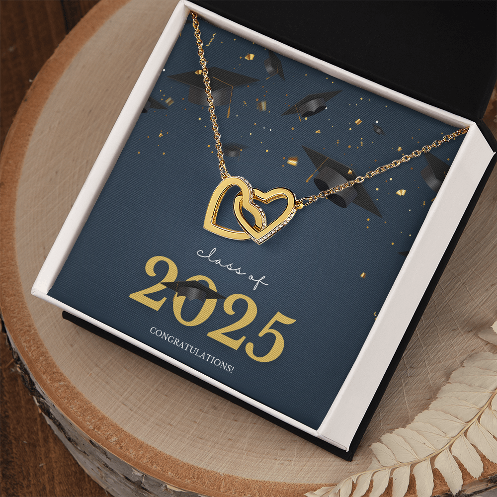 A gold interlocking hearts necklace displayed in a  box with a message card that reads "Class of 2025 – Congratulations" featuring graduation caps and celebratory confetti.