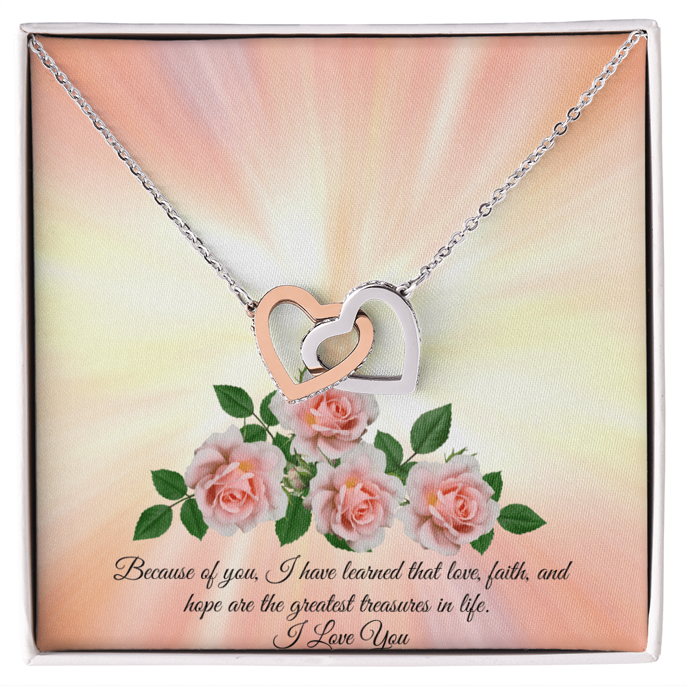 An interlocking hearts necklace with sparkling hearts and rose gold or 18k yellow gold finish, presented in a box with a message card.