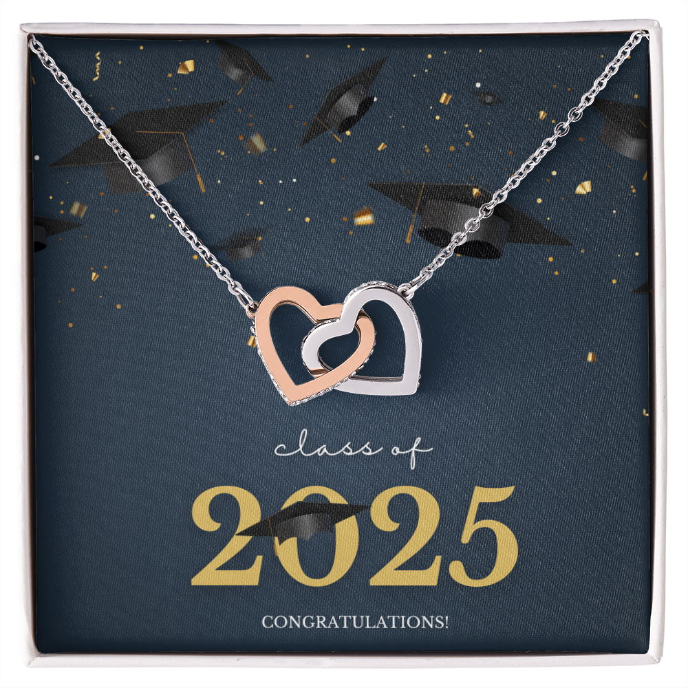 A gold interlocking hearts necklace displayed in a cherry wood box with a message card that reads "Class of 2025 – Congratulations" featuring graduation caps and celebratory confetti.