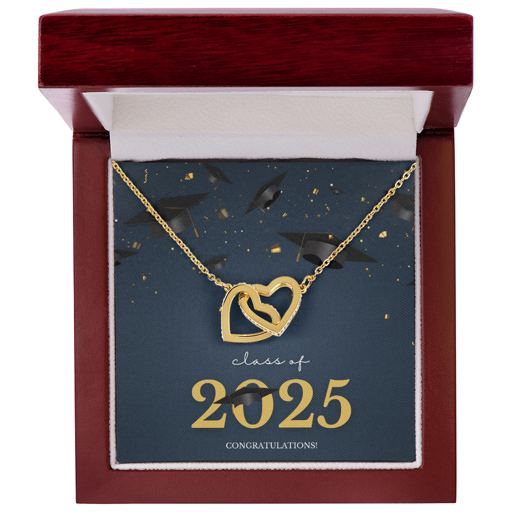 A gold interlocking hearts necklace displayed in a cherry wood box with a message card that reads "Class of 2025 – Congratulations" featuring graduation caps and celebratory confetti.