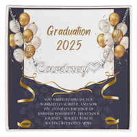 Close-up of hands holding an open red gift box featuring a personalized gold name necklace with heart, set against a message card that reads "Graduation 2025" and includes an inspiring graduation quote, with gold and white balloons in the background.
