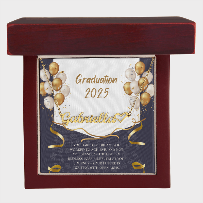 Close-up of hands holding an open red gift box featuring a personalized gold name necklace with heart, set against a message card that reads 