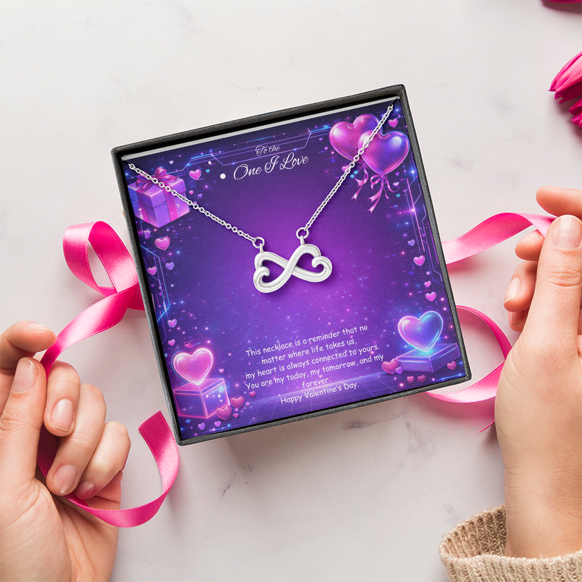 Silver infinity heart necklace displayed in a gift box on a purple Valentine-themed background symbolizing endless love.