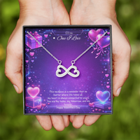 Silver infinity heart necklace displayed in a gift box on a purple Valentine-themed background symbolizing endless love.