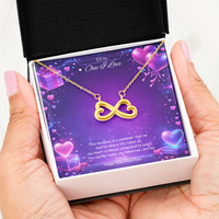 Gold infinity heart necklace displayed in a gift box on a purple Valentine-themed background symbolizing endless love.