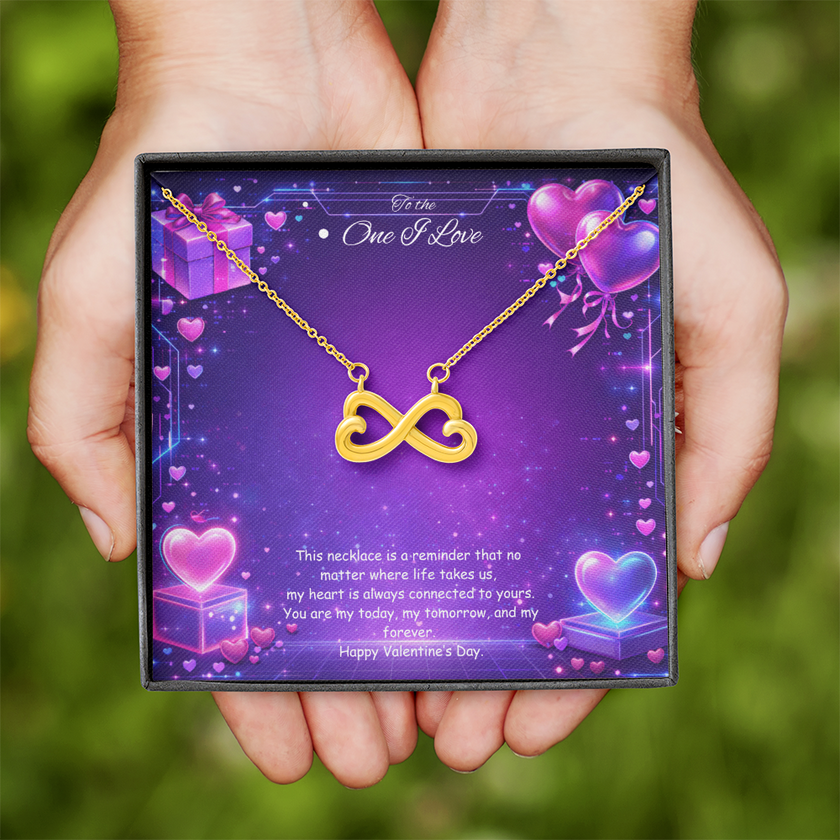 Gold infinity heart necklace displayed in a gift box on a purple Valentine-themed background symbolizing endless love.