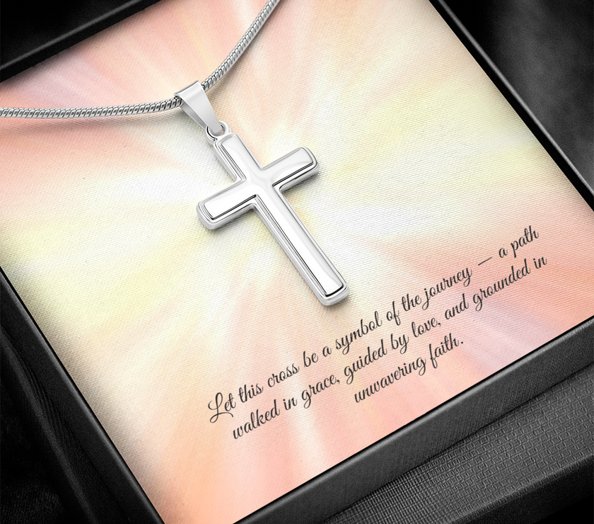 Silver cross necklace displayed in a red gift box with a radiant background and an inspirational message that reads: 'Let this cross be a symbol of the journey — a path walked in grace, guided by love, and grounded in unwavering faith