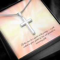 Silver cross necklace displayed in a red gift box with a radiant background and an inspirational message that reads: 'Let this cross be a symbol of the journey — a path walked in grace, guided by love, and grounded in unwavering faith