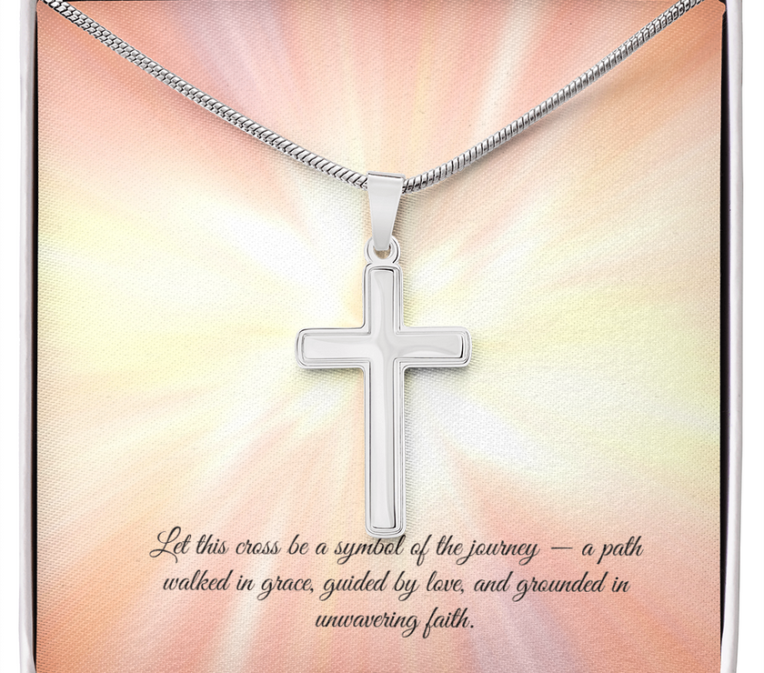 Silver cross necklace displayed in a red gift box with a radiant background and an inspirational message that reads: 'Let this cross be a symbol of the journey — a path walked in grace, guided by love, and grounded in unwavering faith