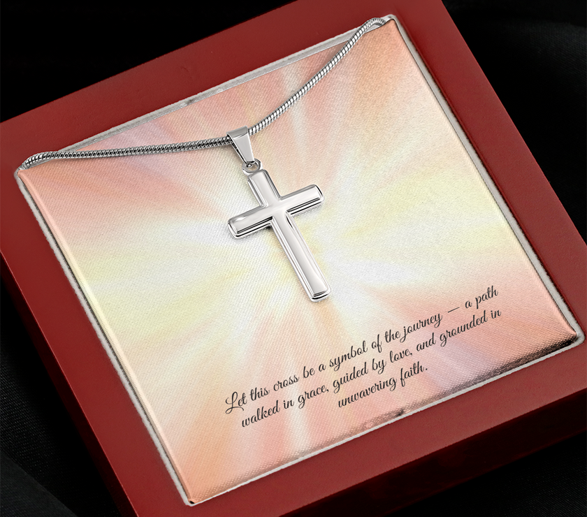 Silver cross necklace displayed in a red gift box with a radiant background and an inspirational message that reads: 'Let this cross be a symbol of the journey — a path walked in grace, guided by love, and grounded in unwavering faith