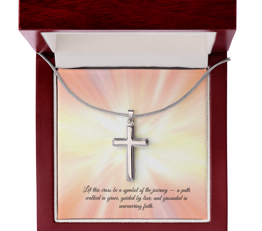 Silver cross necklace displayed in a red gift box with a radiant background and an inspirational message that reads: 'Let this cross be a symbol of the journey — a path walked in grace, guided by love, and grounded in unwavering faith