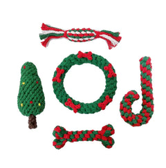 Set of green and red crocheted dog toys on a white background