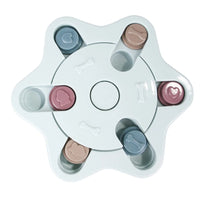 a pastel-colored  puzzle toy - uncover kibble stored beneath the sliders.