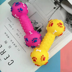 Two colorful dog toys shaped like dumbbells on a magazine page.