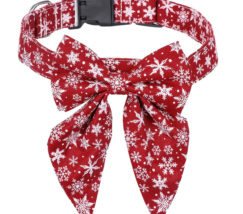 Red dog collar with white snowflake pattern and matching bow tie on a white background