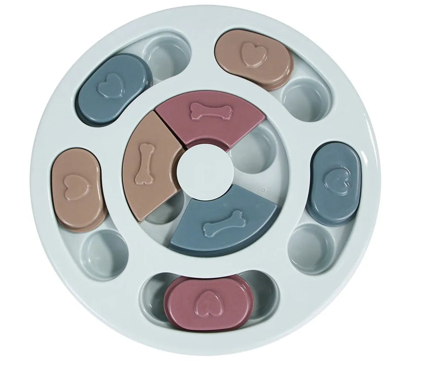 a pastel-colored round shaped puzzle toy - uncover kibble stored beneath the sliders.