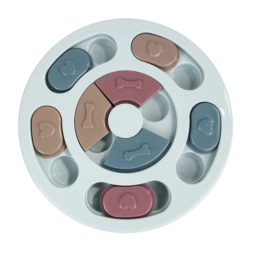 a pastel-colored round shaped puzzle toy - uncover kibble stored beneath the sliders.