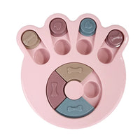 a pastel-colored paw-shaped puzzle toy - uncover kibble stored beneath the sliders.