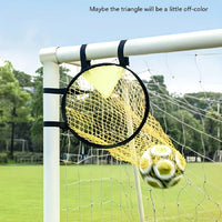 Yellow soccer ball inside a goal net with a clear sky and trees in the background
