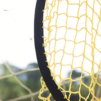 Close-up of a yellow basketball net with a blurred green background