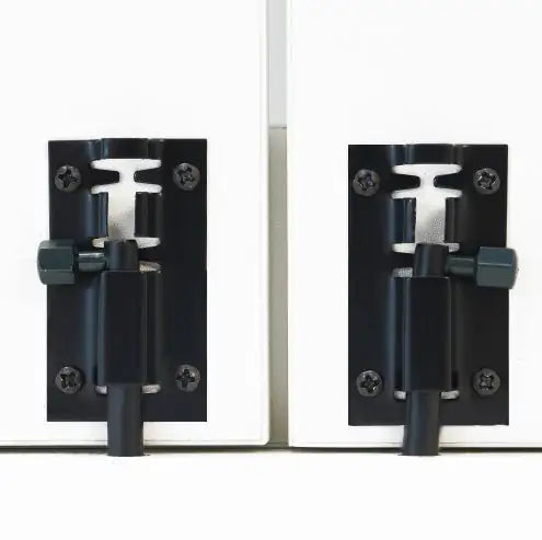 Pair of black metal door hinges on a white background
