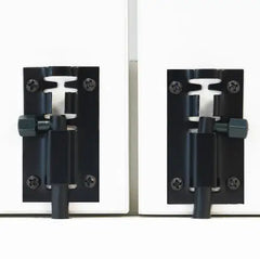 Pair of black metal door hinges on a white background