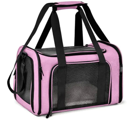 Pink pet carrier with black interior and straps on a white background