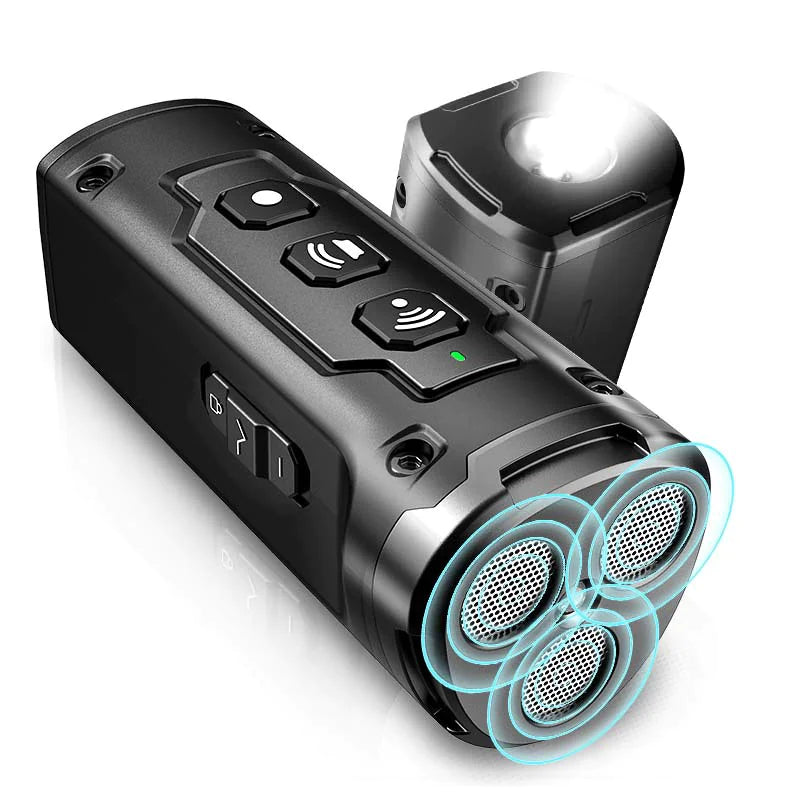 A close-up view of a black handheld ultrasonic dog training device featuring three mesh speaker emitters, control buttons, and an integrated flashlight on top.