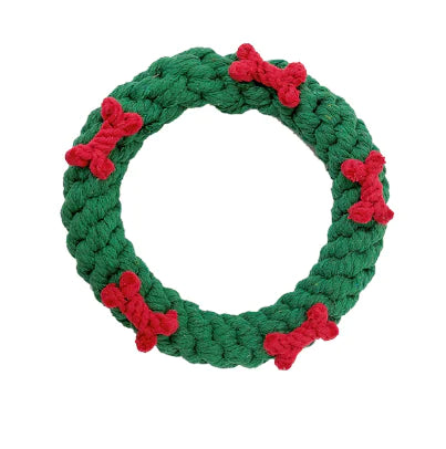 Green rope toy with red bones on a white background