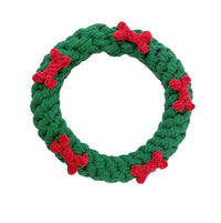 Green rope toy with red bones on a white background