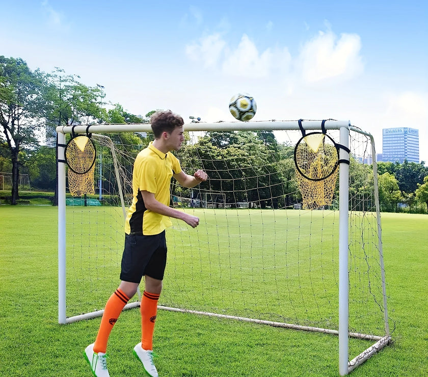 Person playing with a soccer ball on a small goal in a park