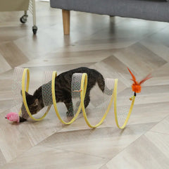 Cat playing with a yellow mesh tunnel toy on a wooden floor.