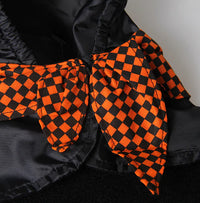 Black and orange checkered fabric on a dark background