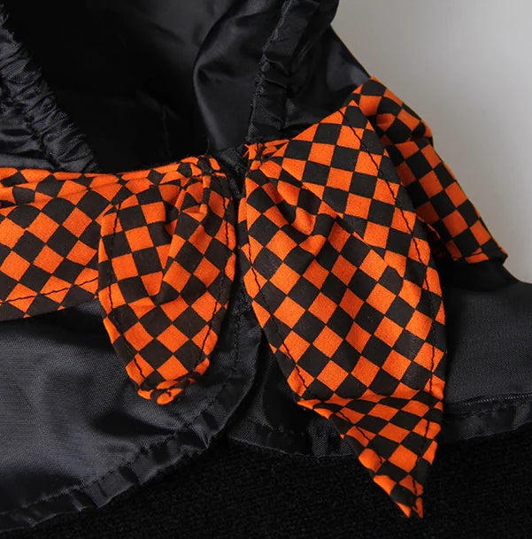 Black and orange checkered fabric on a dark background